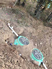 Septic system access risers and pipe connections visible at grade level in Brownwood, TX
