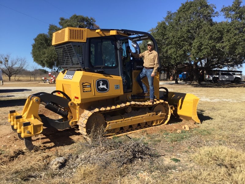 Chris Yarbrough operating a John Deere 450G dozer on a job site near Brownwood, TX